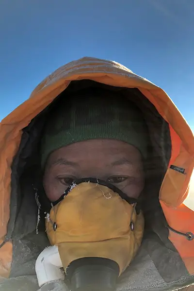 エベレスト登山中、酸素マスクを着用したラクパ・シェルパ