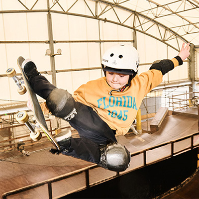 A picture of Ema Kawakami mid-air on a skateboard