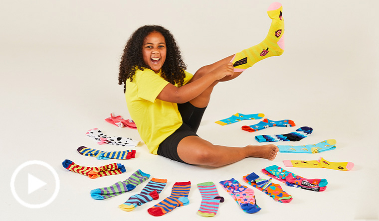 girl putting socks on 