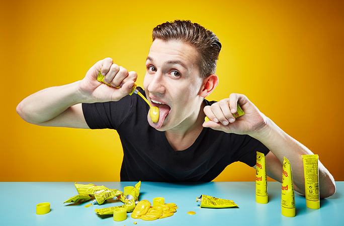 Andre eating packets of mustard