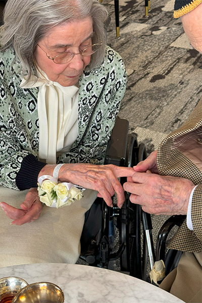 Marjorie and Bernie hold hands
