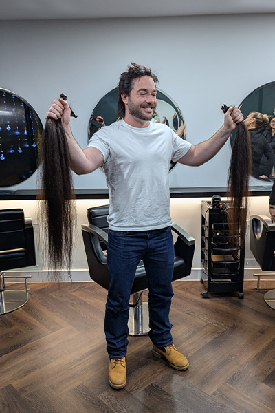 Jack holding up his hair after having it cut off