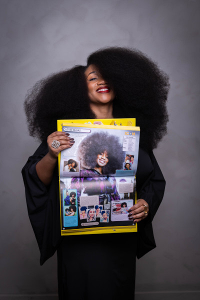 Aevin holding a photo of her in the GWR book