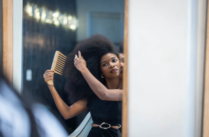 Jess teasing her hair with a comb