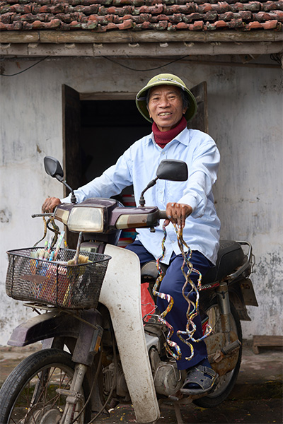 Mr Huyền on his moped