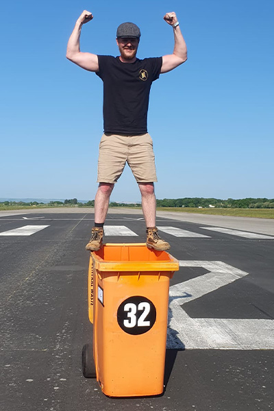 Mike standing on the bin