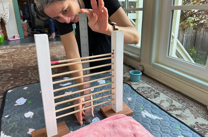 An adult measuring the bar