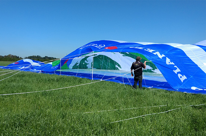 kite on the ground with a person next to it