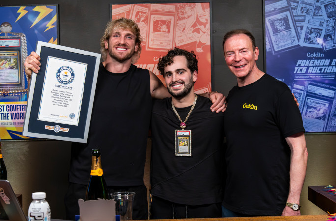 Logan holding the card and certificate