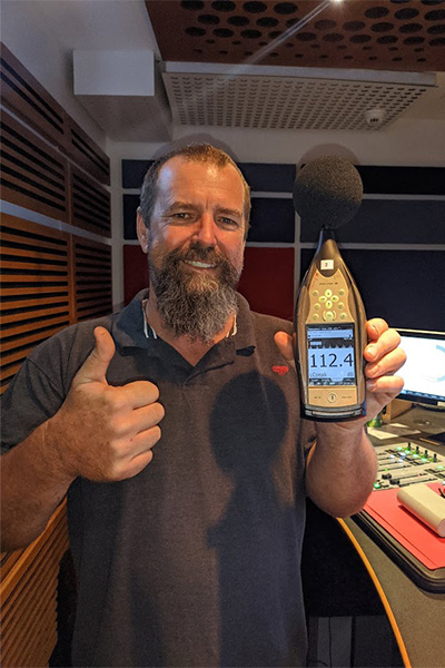 man holding a decibel reader