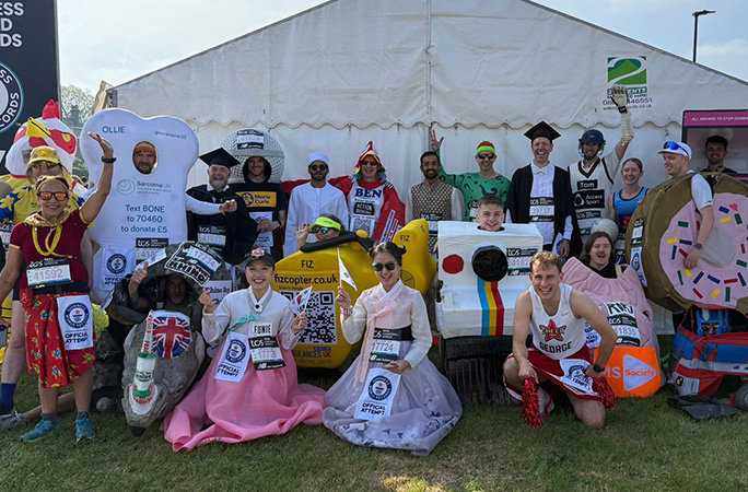 a picture of all runners in their costumes cheer at the starting line