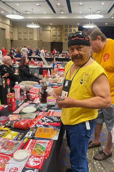 Bardo purchasing Coke memorabilia at a convention