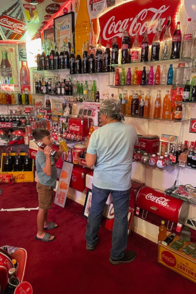 Bardo showing off his Coke bottles to a young boy