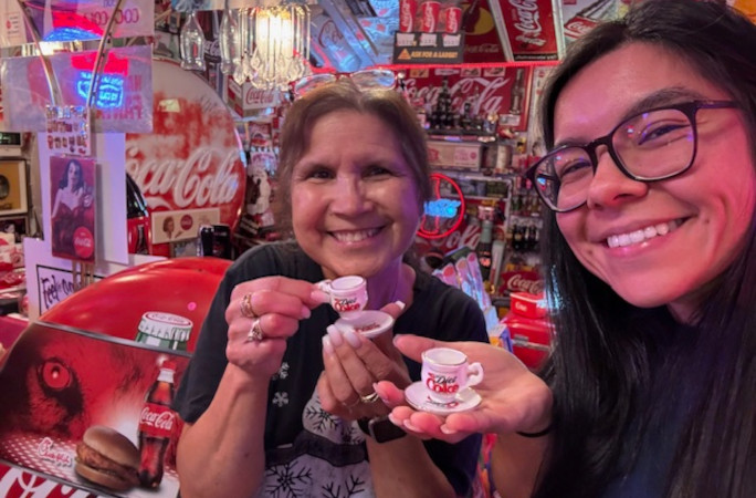 Sam and Olga showing off their tiny Coca Cola cups for the camera