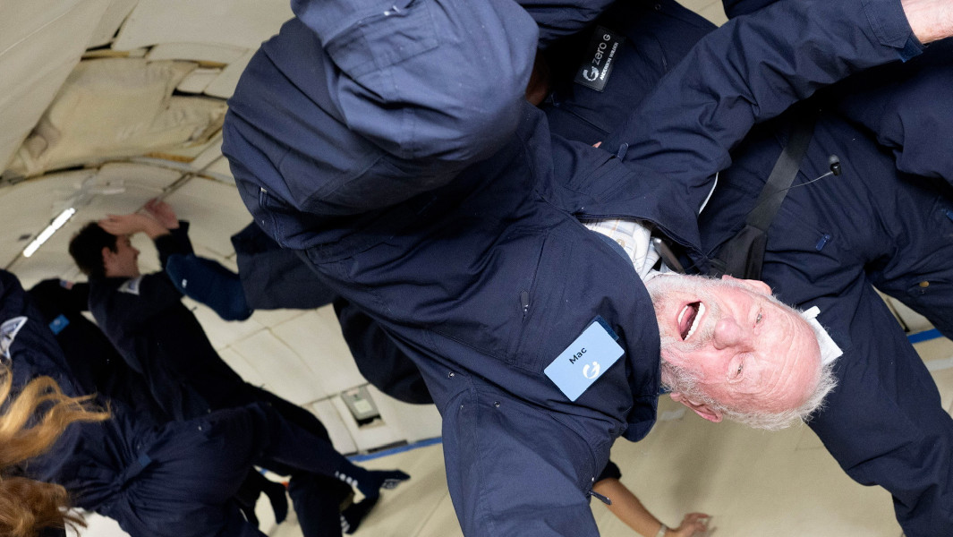 Robert smiling while floating in zero gravity
