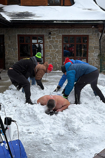 Damian being covered in snow