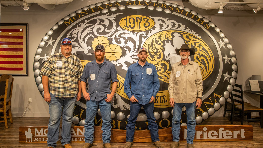 largest belt buckle four men standing in front