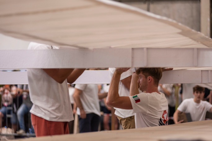 Students holding the underside of the paper plane
