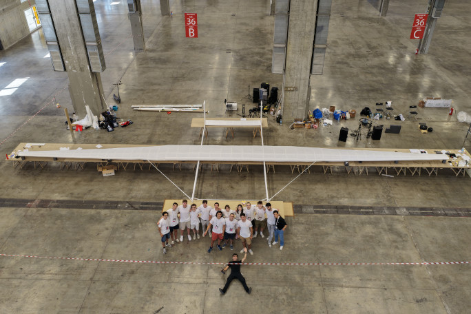 Overhead shot of the team standing next to the giant plane
