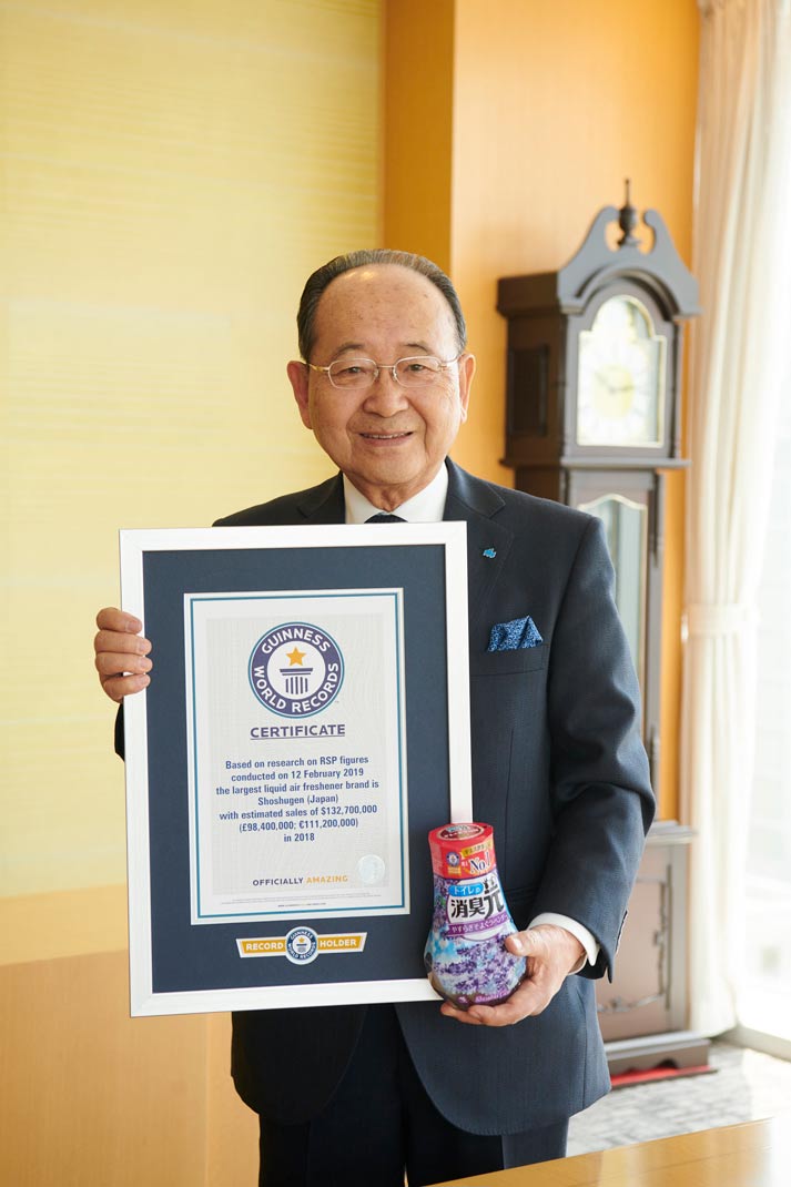 man in navy suit holding gwr certificate
