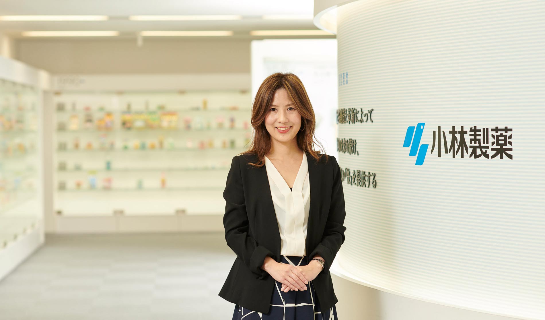 woman in black blazer smiling at camera
