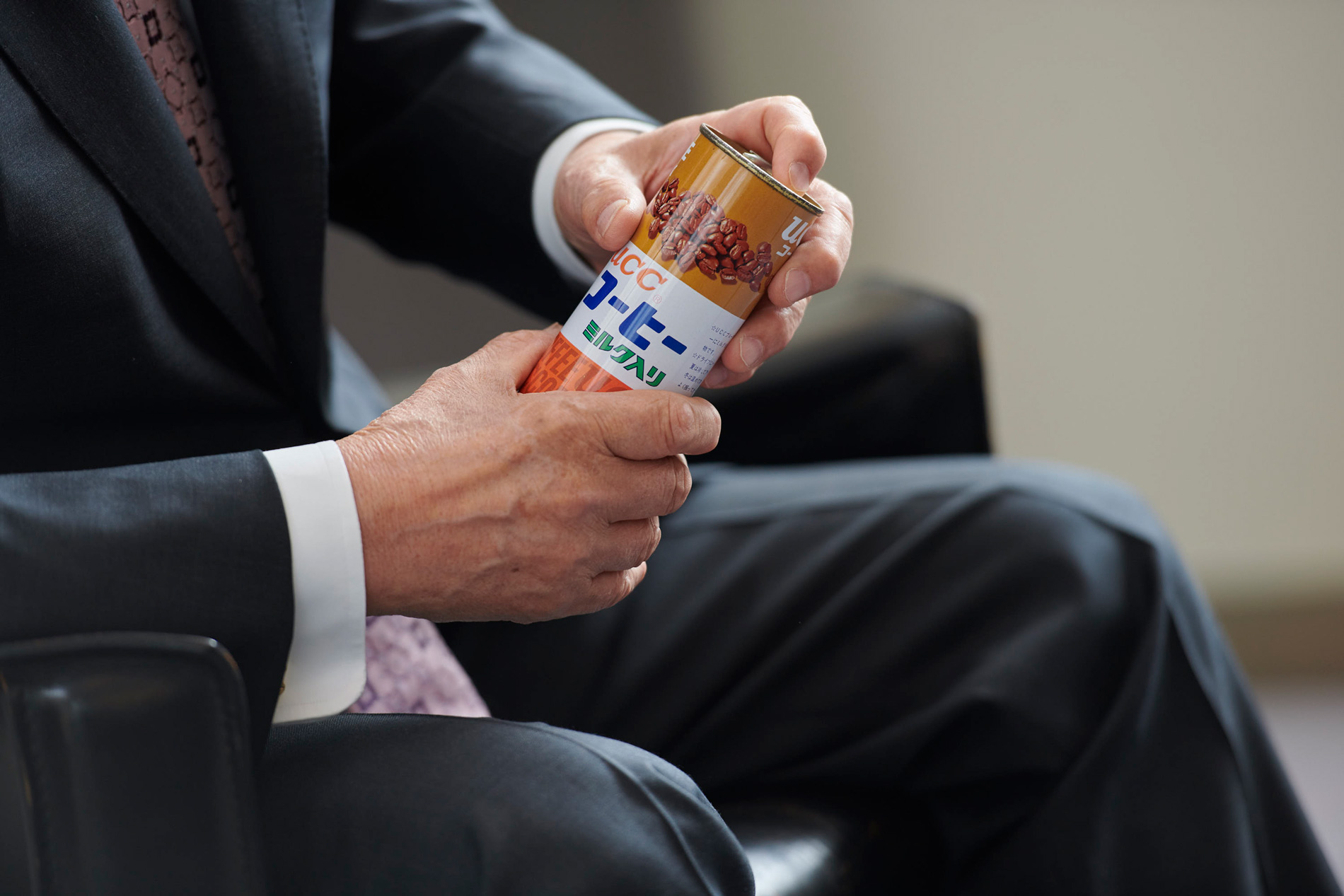 man holding ucc milk coffee can