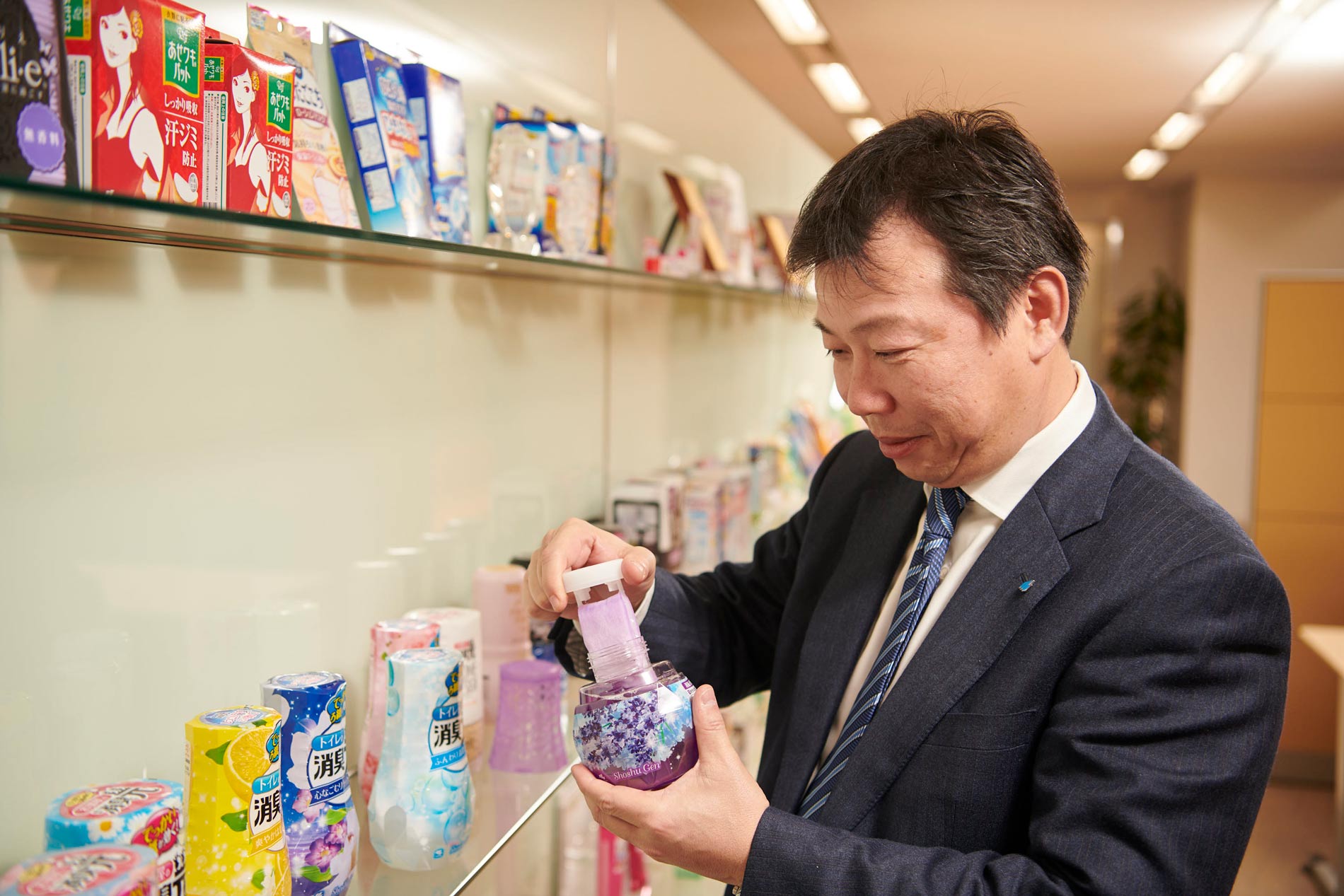 man in suit holding shoshugen product