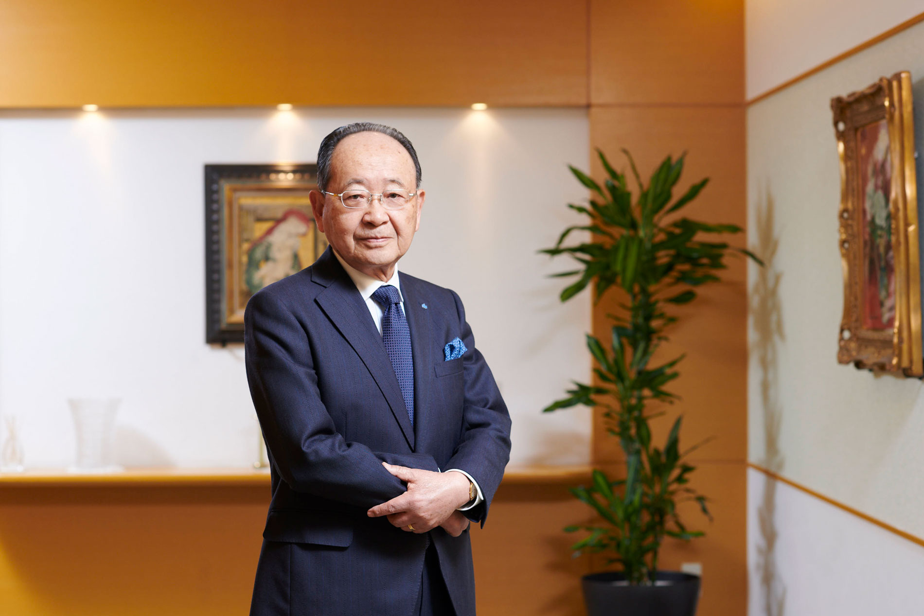 man in navy suit crossing hands