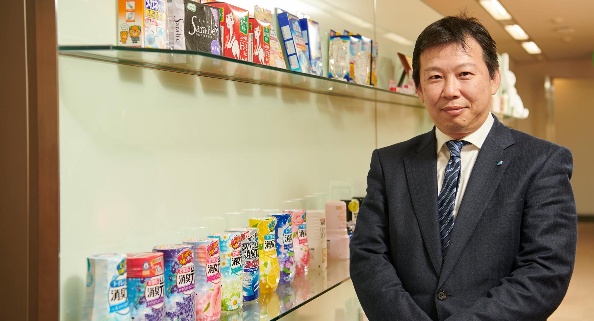 man in suit standing next to shoshugen products