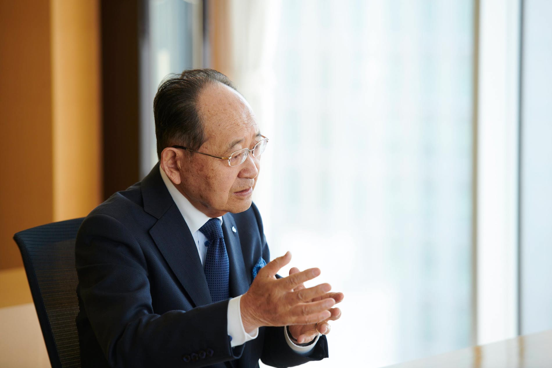 man in navy suit in mid conversation