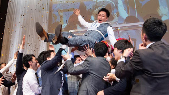 man being thrown in the air with confetti