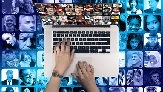 an open laptop with a collage of portraits of people