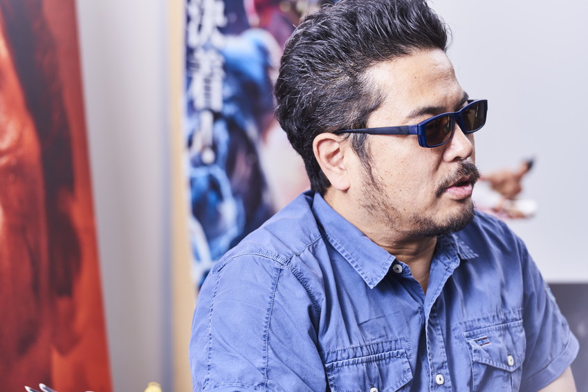 Katsuhiro wearing sunglasses and blue shirt