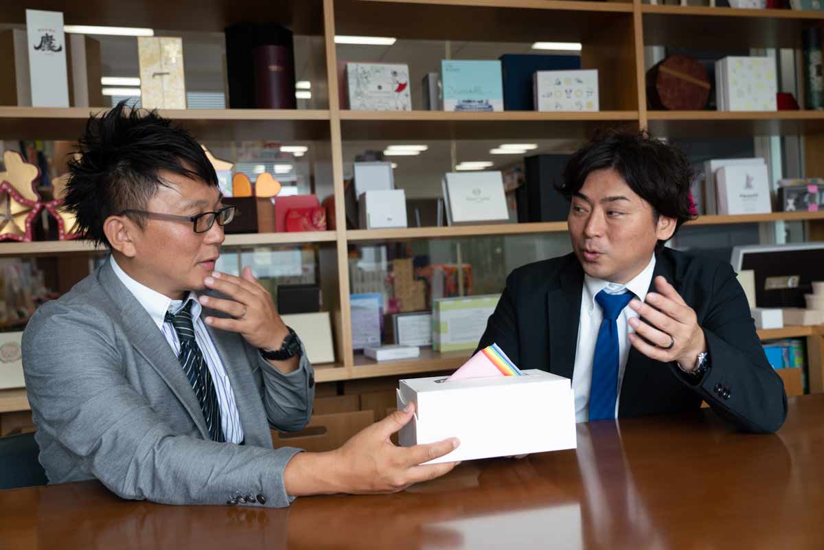 two men talking with napkins on the table