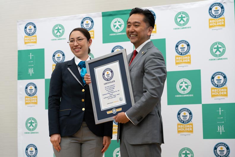 man holding gwr certificate next to adjudicator