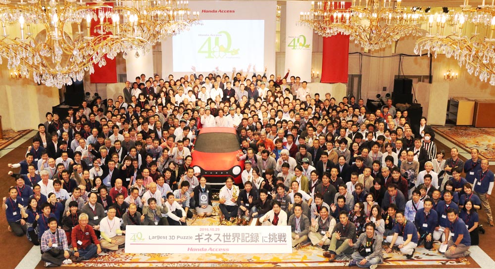 hundreds of people surrounding honda car