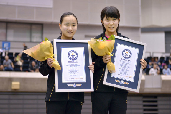 mima and miu holding bouqet of flowers and gwr certifiicates 