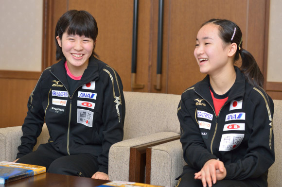 mima and miu sat on chairs laughing 