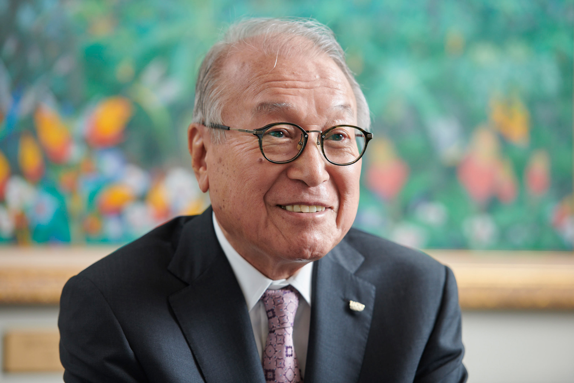 man in suit and glasses smiling
