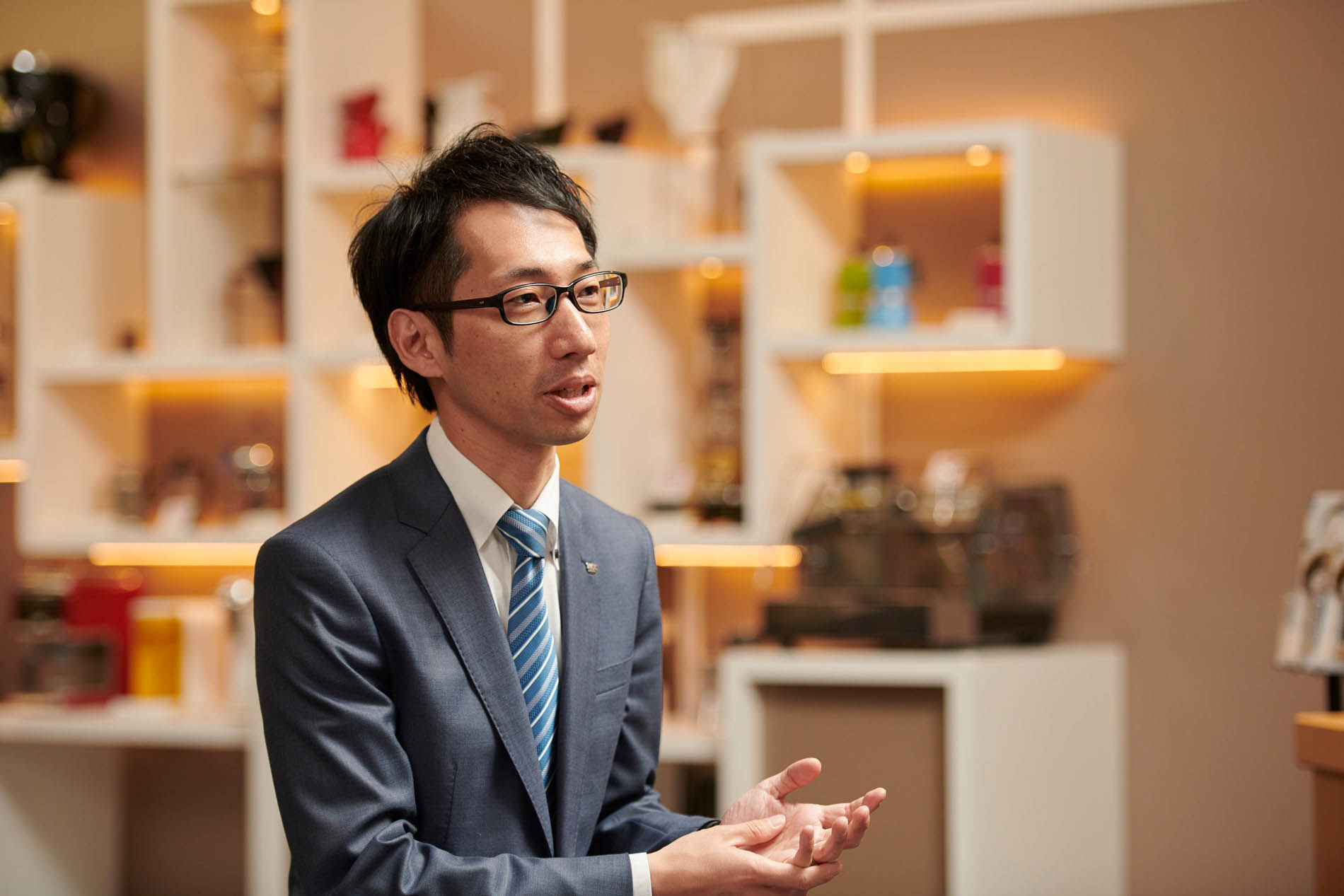 man in grey suit in mid conversation