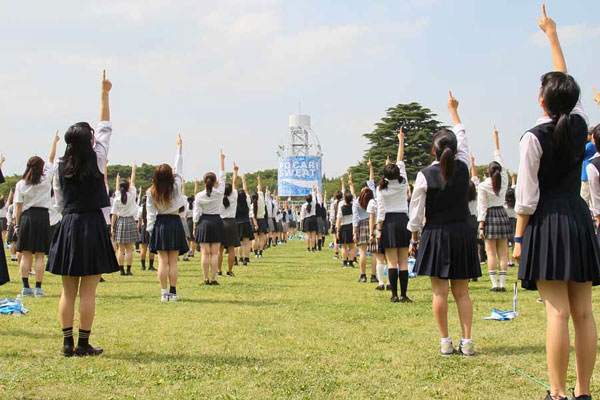 women pointing to sky