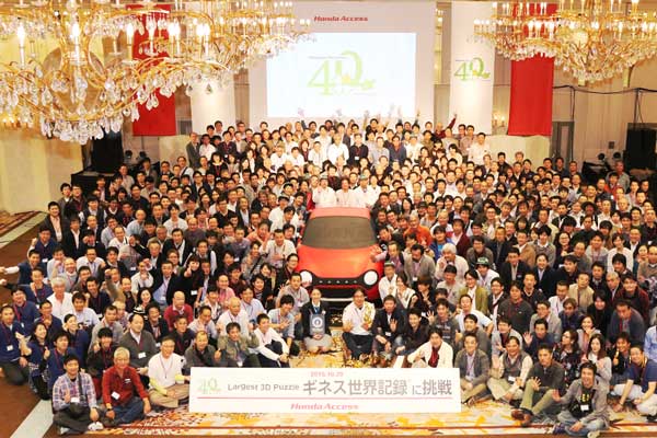 hundreds of people surrounding a honda 