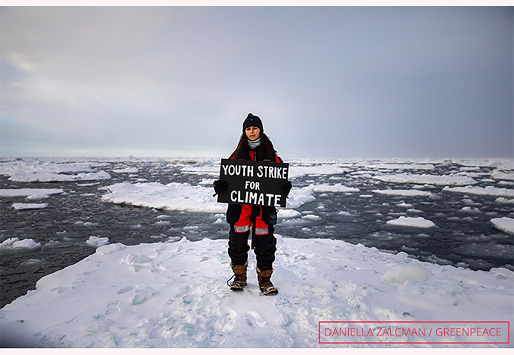 mya rose craig holding sign at most northerly climate protest arctic greenpeace